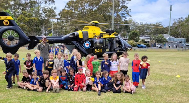 super hero day students had a visit from navy helicopter on thomson street field